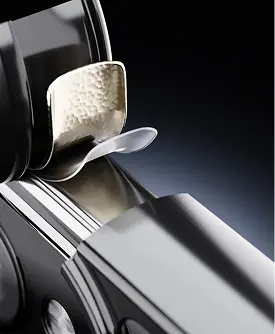 Macro view of a stainless steel cutting blade on an electric trimmer.