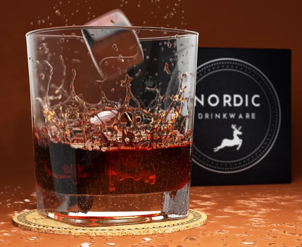 3D product rendering of Nordic Drinkware glass featuring a photorealistic liquid splash, ice cube motion, and condensation on a textured surface.