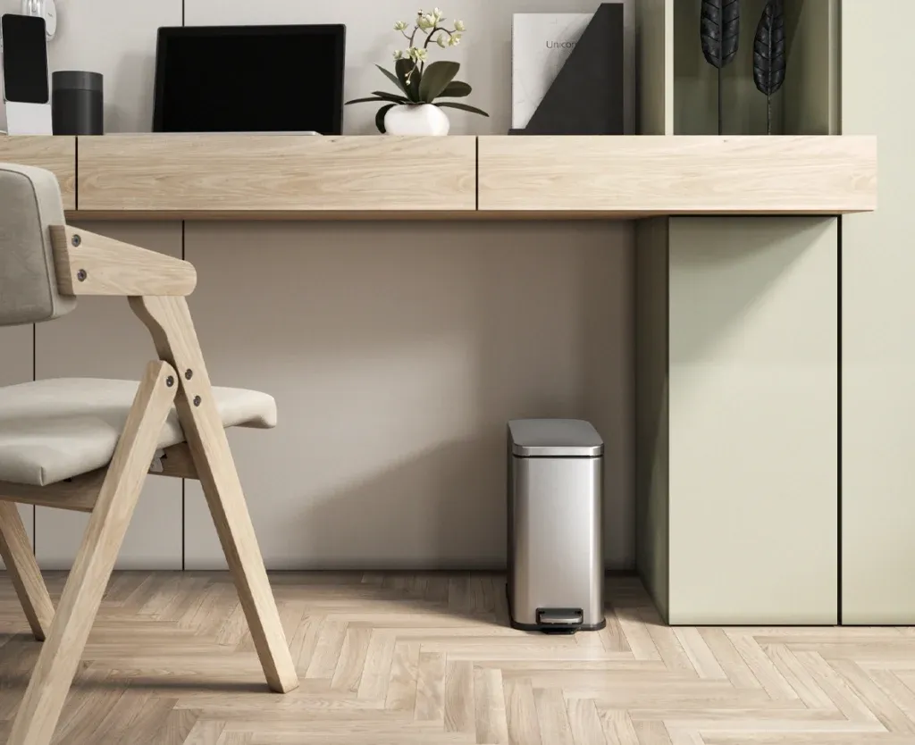 Photorealistic 3D interior rendering of a stainless steel step trash can in a modern minimalist office with herringbone wood floors.