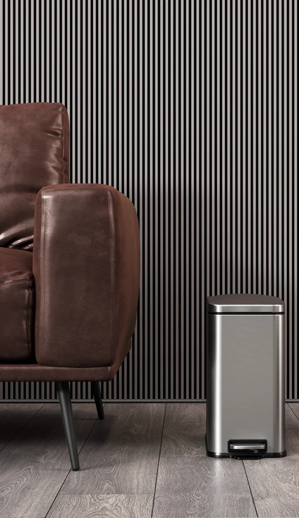 Photorealistic interior 3D rendering of a leather sofa and stainless steel trash can by a 3d environment design studio.
