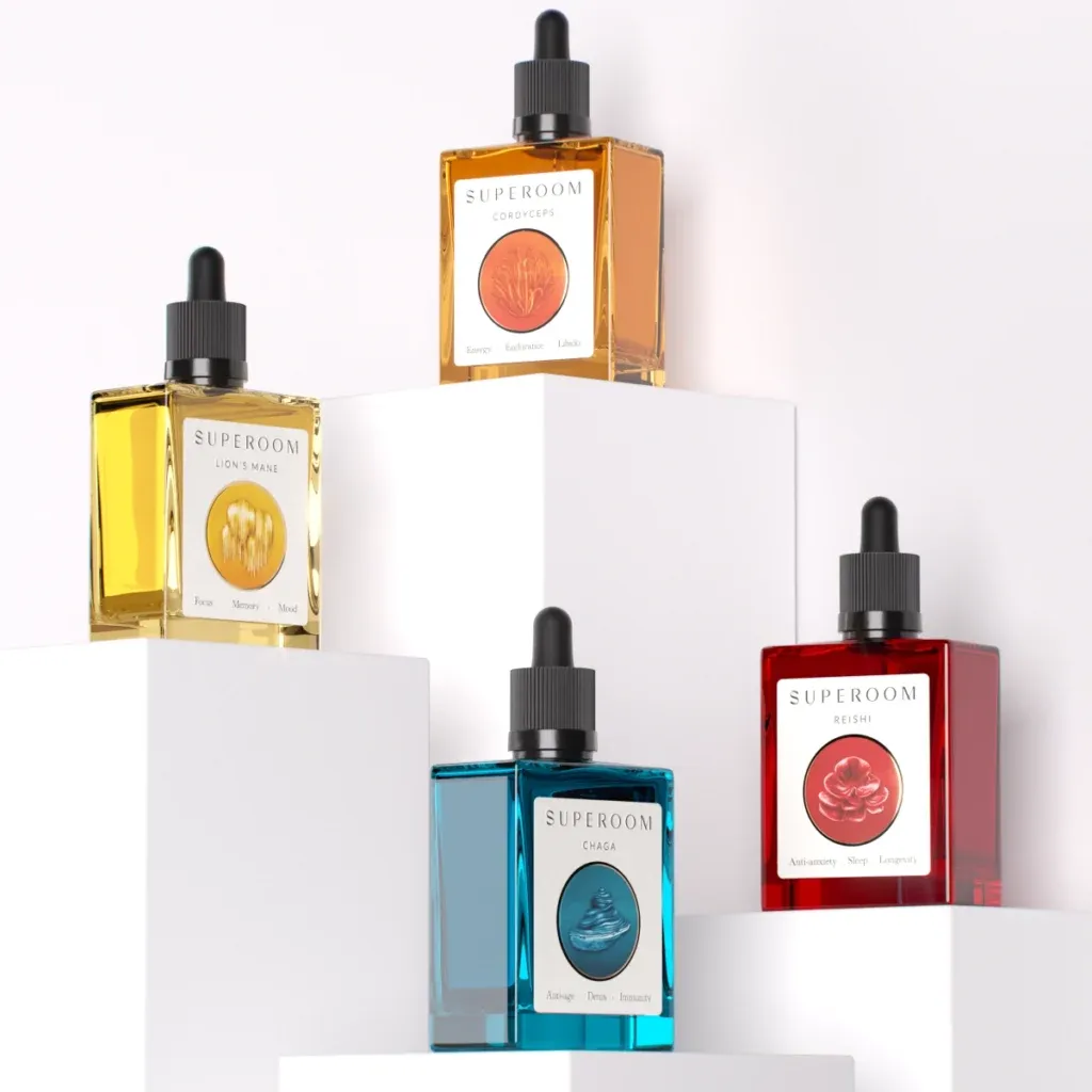 Four Superoom mushroom tincture glass bottles in yellow, orange, blue, and red displayed on white geometric pedestals using 3d packaging rendering.